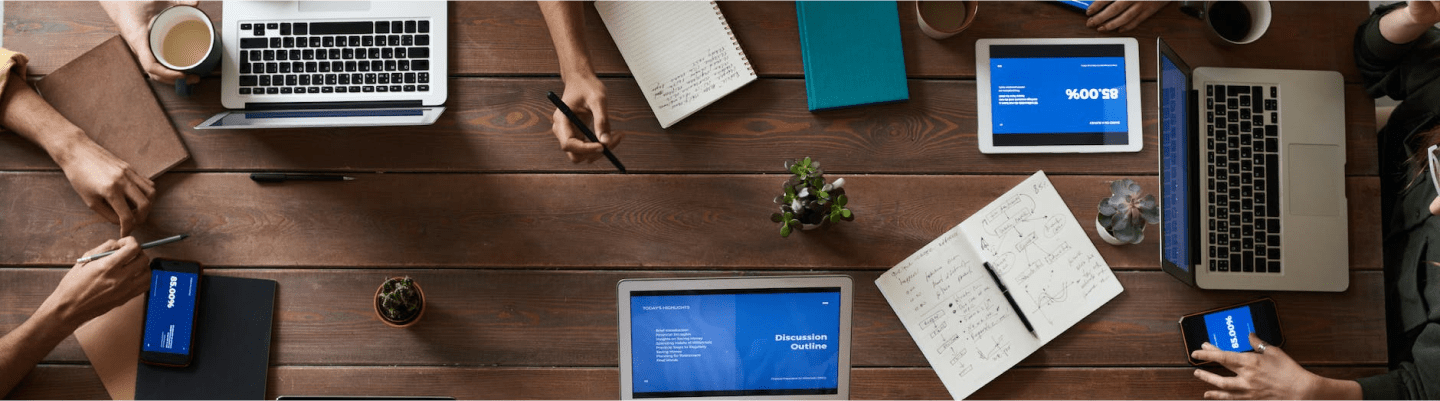 desk with computers and notebooks